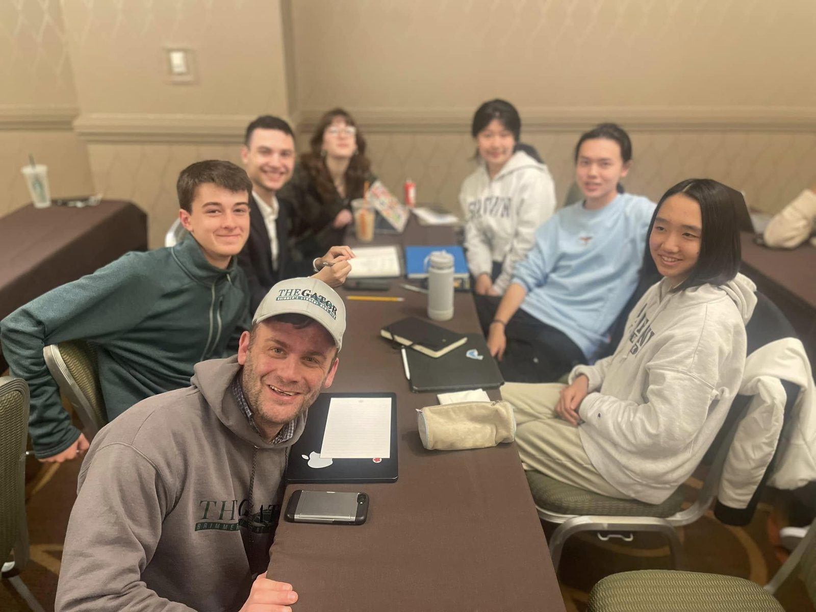 David Cutler and Gator student journalists gather around a table at a journalism convention.