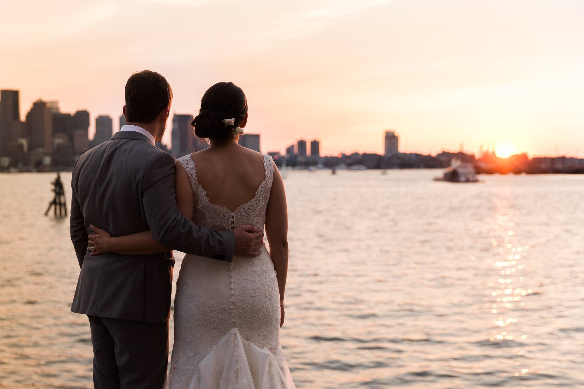 David and Elana together beside the water at sunset, dressed for their wedding.